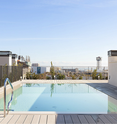 Communal rooftop pool with views over the city