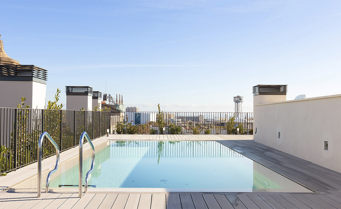 Communal rooftop pool with views over the city